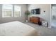 Bedroom with plush carpeting, dresser with TV, and ample natural light at 832 Canonbury St, Henderson, NV 89011