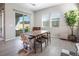 Dining area with access to the backyard featuring a wooden table and natural lighting at 832 Canonbury St, Henderson, NV 89011