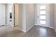 Welcoming foyer showcasing modern tile flooring and a contemporary front door with sidelights at 832 Canonbury St, Henderson, NV 89011