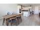Open-concept kitchen and dining area featuring modern appliances, white cabinets, and wood table at 832 Canonbury St, Henderson, NV 89011