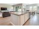Bright kitchen island featuring a stainless sink, white cabinets, and modern countertops at 832 Canonbury St, Henderson, NV 89011