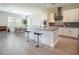 Modern kitchen with island, stainless steel appliances, gray countertops, and tile flooring at 832 Canonbury St, Henderson, NV 89011
