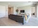 Comfortable living room featuring a large sectional sofa, neutral decor, and tile flooring at 832 Canonbury St, Henderson, NV 89011