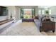 Spacious living area with a large sectional sofa, a shag rug, and a backyard view at 832 Canonbury St, Henderson, NV 89011