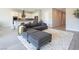 Bright and airy living area with a sectional sofa, tile floors, and a modern kitchen in the background at 832 Canonbury St, Henderson, NV 89011