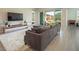 Bright living room featuring a sectional sofa, neutral decor, and sliding glass doors at 832 Canonbury St, Henderson, NV 89011