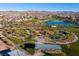 Aerial view of a pond in a park-like setting surrounded by walking paths and residential homes at 832 Canonbury St, Henderson, NV 89011