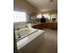 Inviting Primary bathroom with a large soaking tub, abundant counter space, and natural lighting at 9365 Sparkling Waters Ave, Las Vegas, NV 89129