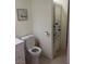 Bathroom showcasing a toilet and shower with fish themed curtain near the door at 9365 Sparkling Waters Ave, Las Vegas, NV 89129