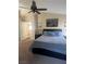 Well-lit bedroom featuring access to the hallway and a comfortable space with neutral colors and ceiling fan at 9365 Sparkling Waters Ave, Las Vegas, NV 89129
