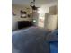 Comfortable bedroom setup with a ceiling fan, fireplace, and an open view into the kitchen area at 9365 Sparkling Waters Ave, Las Vegas, NV 89129