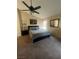 Spacious bedroom features a large bed, ceiling fan, ample lighting, and neutral carpet at 9365 Sparkling Waters Ave, Las Vegas, NV 89129