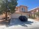 Charming two-story home features a well-manicured front yard and a spacious three-car garage at 9365 Sparkling Waters Ave, Las Vegas, NV 89129