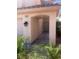 Covered front porch featuring neutral colored stucco and manicured tropical landscaping at 9365 Sparkling Waters Ave, Las Vegas, NV 89129