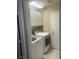 Well-lit laundry room equipped with a modern white washer and dryer at 9365 Sparkling Waters Ave, Las Vegas, NV 89129