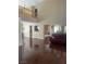 Spacious open-plan living area with hardwood floors and a view of the second-floor balcony at 9365 Sparkling Waters Ave, Las Vegas, NV 89129