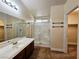Neutral toned bathroom showcasing a white sink, a framed shower, and a doorway to the walk-in closet at 9462 Alhambra Valley St, Las Vegas, NV 89178