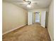 A bright, neutral-toned bedroom featuring a ceiling fan and an open doorway to other rooms at 9462 Alhambra Valley St, Las Vegas, NV 89178