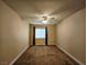 A bedroom with neutral walls, carpeting, a ceiling fan and a single window at 9462 Alhambra Valley St, Las Vegas, NV 89178