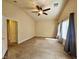A spacious bedroom with neutral walls, a ceiling fan, and ample natural light from the windows at 9462 Alhambra Valley St, Las Vegas, NV 89178