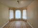 Cozy dining area with ample natural light from large windows; neutral color palette at 9462 Alhambra Valley St, Las Vegas, NV 89178
