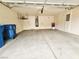 Spacious garage area for parking and storage, with attached water heater and trash cans at 9462 Alhambra Valley St, Las Vegas, NV 89178