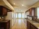 Bright kitchen with white refrigerator and plenty of counter space; living area view at 9462 Alhambra Valley St, Las Vegas, NV 89178