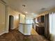 Open kitchen featuring dark wood cabinets, granite countertops, and modern appliances at 9462 Alhambra Valley St, Las Vegas, NV 89178