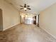 Open-concept living room with neutral carpet, view into kitchen and dining room at 9462 Alhambra Valley St, Las Vegas, NV 89178