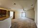 Spacious living room featuring neutral carpet, ceiling fan, and sliding glass door access at 9462 Alhambra Valley St, Las Vegas, NV 89178