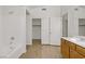 Bathroom features a tub, shower combo, and sliding door closet, with a wood-grain floor at 9535 Stills Way, Las Vegas, NV 89148