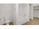 Clean bathroom featuring a toilet and shower-tub, with a wood-grain floor at 9535 Stills Way, Las Vegas, NV 89148