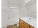 Bathroom with white vanity and tub/shower combination with white tile surround at 9535 Stills Way, Las Vegas, NV 89148