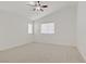 Cozy bedroom featuring a ceiling fan, natural light from the windows, and neutral carpeting for comfort at 9535 Stills Way, Las Vegas, NV 89148