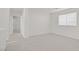 Neutral bedroom with carpet and a window; open door to hallway at 9535 Stills Way, Las Vegas, NV 89148