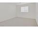 Bright bedroom features neutral carpet, window with blinds, and neutral walls at 9535 Stills Way, Las Vegas, NV 89148