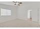 This spacious bedroom features natural light from windows and neutral carpeting, creating an inviting space at 9535 Stills Way, Las Vegas, NV 89148