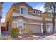 Inviting two-story home featuring desert landscaping and an attached two-car garage at 9535 Stills Way, Las Vegas, NV 89148