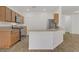 Modern kitchen featuring stainless steel appliances, a functional island, and wood-look flooring at 9535 Stills Way, Las Vegas, NV 89148