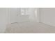 Large living room with neutral carpet and bright white walls at 9535 Stills Way, Las Vegas, NV 89148