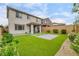 Well-maintained backyard with lush artificial turf, a paved patio area, and mature landscaping, ideal for relaxation at 9876 Heather Moore Ave, Las Vegas, NV 89166