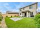 Inviting backyard featuring artificial turf, a paved patio, and low-maintenance landscaping, perfect for outdoor entertaining at 9876 Heather Moore Ave, Las Vegas, NV 89166