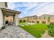 Beautiful backyard featuring a paved patio, artificial turf, and manicured landscaping, perfect for outdoor living at 9876 Heather Moore Ave, Las Vegas, NV 89166