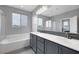 Modern bathroom featuring double sinks, stylish fixtures, and a separate glass-enclosed shower at 9876 Heather Moore Ave, Las Vegas, NV 89166