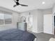 Serene bedroom features gray walls, a ceiling fan, and a glimpse into an adjoining spa-like bathroom at 9876 Heather Moore Ave, Las Vegas, NV 89166