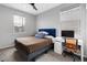 Functional bedroom featuring a built-in desk, cozy bed, and ample natural light for work and rest at 9876 Heather Moore Ave, Las Vegas, NV 89166