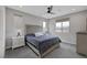 Neutral bedroom with a patterned headboard, ceiling fan, and ample natural light at 9876 Heather Moore Ave, Las Vegas, NV 89166