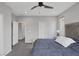 Bright bedroom showcases a cozy bed and neutral decor, enhanced by natural light and a ceiling fan at 9876 Heather Moore Ave, Las Vegas, NV 89166