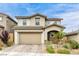 Charming two-story home featuring a two-car garage, stucco exterior, and tiled roof at 9876 Heather Moore Ave, Las Vegas, NV 89166