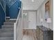 Bright hallway with a staircase, modern lighting fixtures, and stylish decor at 9876 Heather Moore Ave, Las Vegas, NV 89166